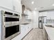 Modern kitchen with stainless steel appliances and white cabinets at 5616 Arborvista Dr, St Cloud, FL 34771
