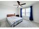 Bright bedroom with a queen bed, ceiling fan, and two windows at 5616 Arborvista Dr, St Cloud, FL 34771