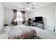 Bright bedroom with king bed, workspace, and ceiling fan at 5616 Arborvista Dr, St Cloud, FL 34771