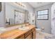 Bathroom with a wood vanity, shower/tub combo and mirrored medicine cabinet at 894 Quarters Ct, Port Orange, FL 32129