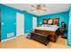 Main bedroom with a king-size bed and teal colored walls at 894 Quarters Ct, Port Orange, FL 32129