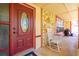 Front porch with rocking chair and red door entry at 894 Quarters Ct, Port Orange, FL 32129
