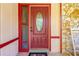 Inviting red front door with sidelights and rocking chair at 894 Quarters Ct, Port Orange, FL 32129