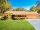 Ranch style home with attached garage and manicured lawn at 894 Quarters Ct, Port Orange, FL 32129