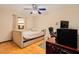 Bedroom with a queen bed, ceiling fan, and home office setup at 894 Quarters Ct, Port Orange, FL 32129