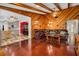 Spacious living room features hardwood floors, a wood-burning fireplace, and exposed beams at 894 Quarters Ct, Port Orange, FL 32129
