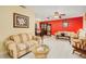 Living room with tiled floors, neutral colored furniture, and an accent wall at 894 Quarters Ct, Port Orange, FL 32129
