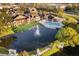 Aerial view of community pool, lake, and buildings at 4400 Thornbriar Ln # A202, Orlando, FL 32822