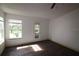 Bright bedroom with laminate flooring and access to a balcony at 4400 Thornbriar Ln # A202, Orlando, FL 32822