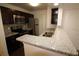 Modern kitchen features granite countertops, stainless steel appliances, and dark wood cabinets at 4400 Thornbriar Ln # A202, Orlando, FL 32822