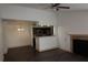 Spacious living room with dark laminate wood flooring, a fireplace, and access to the kitchen at 4400 Thornbriar Ln # A202, Orlando, FL 32822