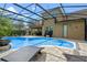 Inviting pool area with covered patio and lounge chairs at 16328 Wind View Ln, Winter Garden, FL 34787