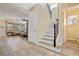 Staircase with wooden railing, light colored steps, and flooring at 16328 Wind View Ln, Winter Garden, FL 34787