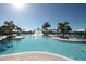 Large community pool with a fountain and lounge chairs at 16328 Wind View Ln, Winter Garden, FL 34787