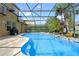 Freeform pool with a screened enclosure and patio at 16328 Wind View Ln, Winter Garden, FL 34787