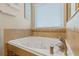 Relax in this spa-like bathroom featuring a large corner jacuzzi tub at 16328 Wind View Ln, Winter Garden, FL 34787