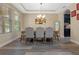 Elegant dining room with hardwood floors, chandelier, and built-in wine storage at 16328 Wind View Ln, Winter Garden, FL 34787