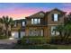 Two-story house with a three-car garage and landscaped yard at 16328 Wind View Ln, Winter Garden, FL 34787