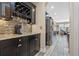 Butler's pantry with granite counters, wine rack, and dark wood cabinetry at 16328 Wind View Ln, Winter Garden, FL 34787