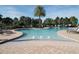 Community pool with lounge chairs and palm trees at 16328 Wind View Ln, Winter Garden, FL 34787