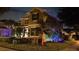 Night view of two-story house with colorful landscape lighting at 16328 Wind View Ln, Winter Garden, FL 34787
