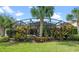 Screened pool and patio area with tropical plants at 16328 Wind View Ln, Winter Garden, FL 34787
