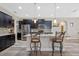 Modern kitchen boasting granite countertops, dark cabinetry, and a breakfast bar at 16328 Wind View Ln, Winter Garden, FL 34787
