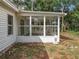 Exterior view of a screened porch with glass panels and white siding at 16132 Plum Lake Ct, Minneola, FL 34715