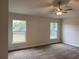 Main bedroom with ceiling fan and two large windows at 4306 Sagefield Dr, Harmony, FL 34773