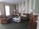 Living room offers a comfy sofa and striped accent chair at 4113 Enchanted Oaks Cir # 1216, Kissimmee, FL 34741