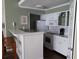 Bright kitchen features white cabinets, a breakfast bar, and modern appliances at 4113 Enchanted Oaks Cir # 1216, Kissimmee, FL 34741
