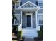 Gray house exterior with a white porch, black front door, and landscaping at 14460 Clarkson Dr, Orlando, FL 32828