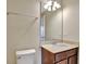 Bathroom boasts a vanity with granite countertop and a large mirror at 720 Calabria Way, Howey In The Hills, FL 34737