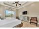 Main bedroom with a king-size bed and sliding doors leading to a pool view at 364 Muirfield Loop, Reunion, FL 34747
