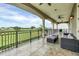 Large balcony overlooking golf course with seating area for relaxing at 364 Muirfield Loop, Reunion, FL 34747