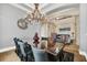 Elegant dining room featuring a large table, chandelier, and stylish decor at 364 Muirfield Loop, Reunion, FL 34747