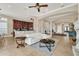 Bright living room with white sofa, open floor plan, and kitchen views at 364 Muirfield Loop, Reunion, FL 34747