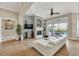 Spacious living room with white sectional sofa, fireplace and pool view at 364 Muirfield Loop, Reunion, FL 34747
