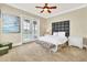 Bright bedroom with a queen bed, balcony access, and picturesque views at 364 Muirfield Loop, Reunion, FL 34747