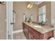 Double vanity bathroom with granite countertops and dark wood cabinets at 364 Muirfield Loop, Reunion, FL 34747