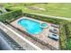 Elevated view of kidney-shaped pool with spa and lounge chairs; fenced backyard at 364 Muirfield Loop, Reunion, FL 34747