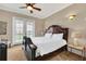 Spacious bedroom with king-size bed, access to balcony, and stunning views at 364 Muirfield Loop, Reunion, FL 34747