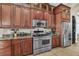Well-equipped kitchen featuring wood cabinets and stainless steel appliances at 364 Muirfield Loop, Reunion, FL 34747