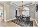 Formal dining room with a chandelier and large windows at 364 Muirfield Loop, Reunion, FL 34747