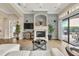 Relaxing living room with white sofa, fireplace, and access to patio at 364 Muirfield Loop, Reunion, FL 34747
