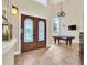 Two-story foyer with double doors and pool table at 364 Muirfield Loop, Reunion, FL 34747
