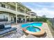 Large kidney shaped pool with spa and patio area next to the house at 364 Muirfield Loop, Reunion, FL 34747