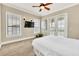 Comfortable bedroom with a queen bed and access to a private balcony at 364 Muirfield Loop, Reunion, FL 34747