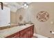 Bathroom with granite countertop, dark wood cabinets, and decorative wall accents at 364 Muirfield Loop, Reunion, FL 34747