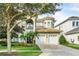 Elegant two-story home with a three-car garage and lush landscaping at 364 Muirfield Loop, Reunion, FL 34747